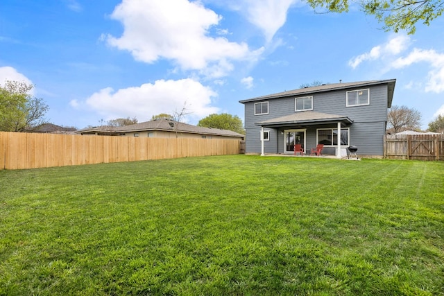 back of property featuring a patio and a lawn