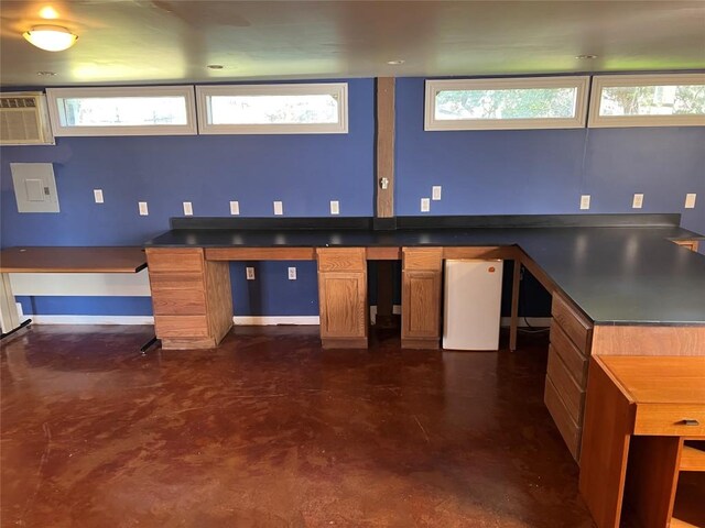 kitchen with a wall unit AC, refrigerator, and electric panel