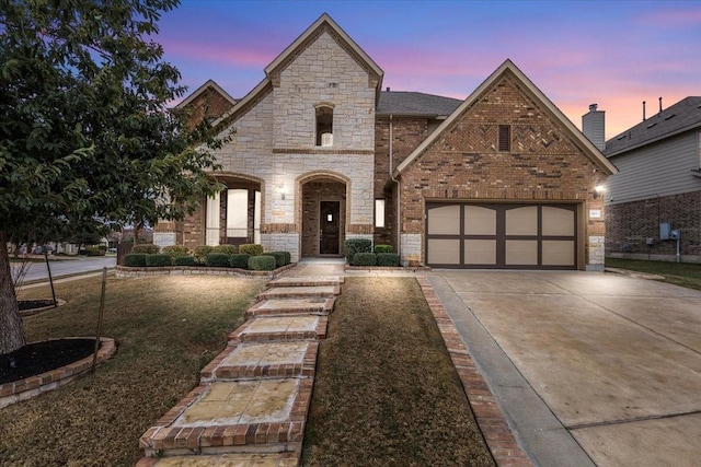 french provincial home featuring a garage