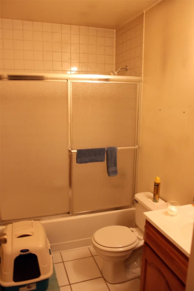 full bathroom featuring shower / bath combination with glass door, toilet, tile patterned floors, and vanity