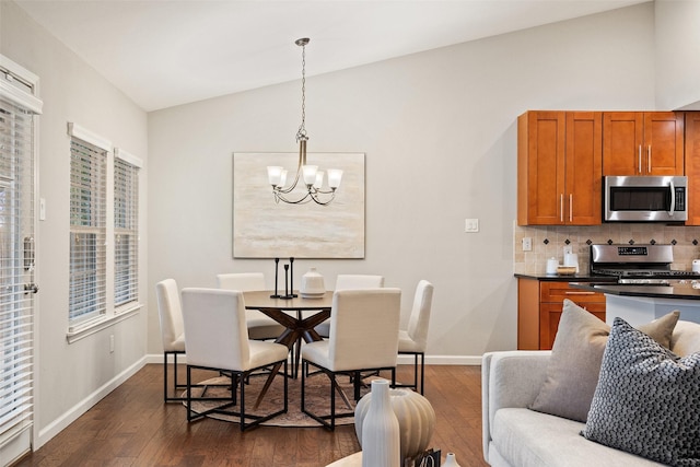 dining space with vaulted ceiling, an inviting chandelier, and dark hardwood / wood-style floors