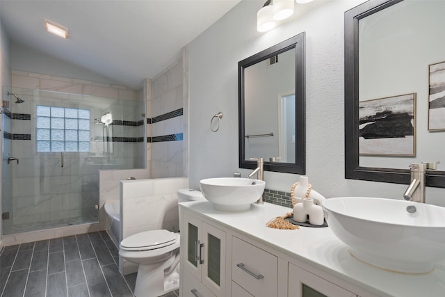 full bathroom featuring toilet, vanity, lofted ceiling, and shower with separate bathtub