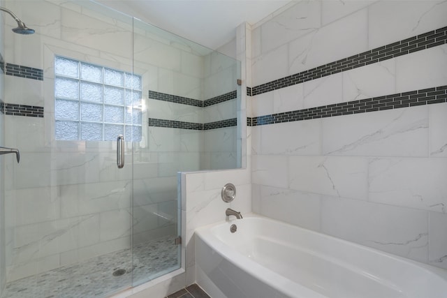 bathroom with tile patterned flooring and shower with separate bathtub