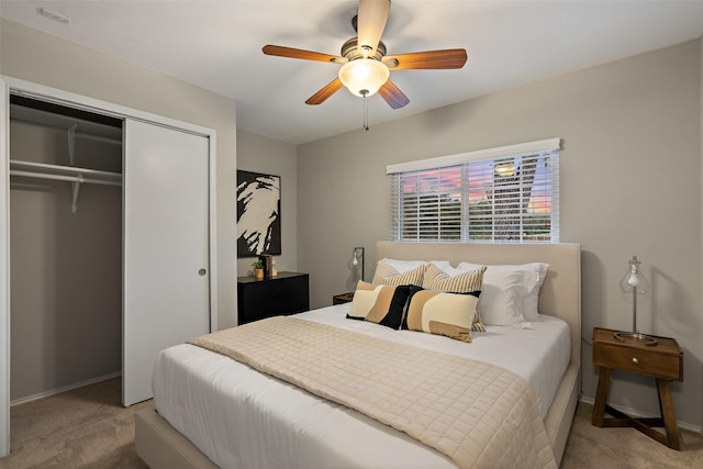 carpeted bedroom featuring ceiling fan and a closet