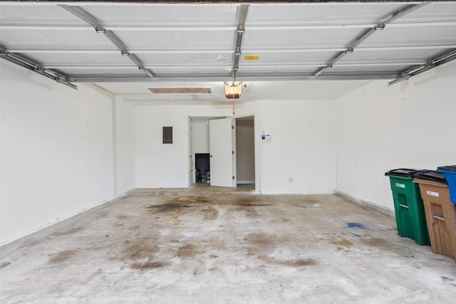 garage featuring electric panel and a garage door opener