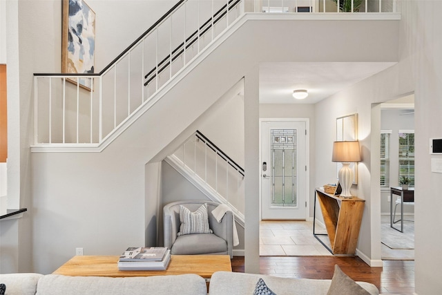 entryway with a towering ceiling and wood-type flooring