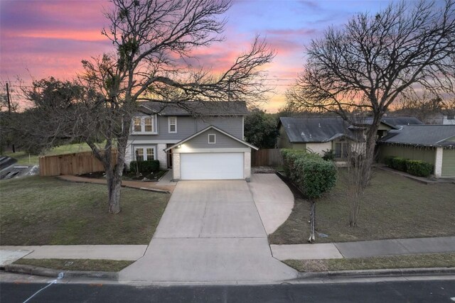 view of front of property featuring a garage and a yard