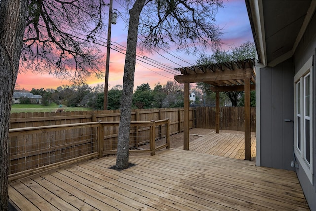 deck at dusk featuring a pergola