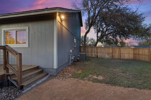 property exterior at dusk featuring cooling unit