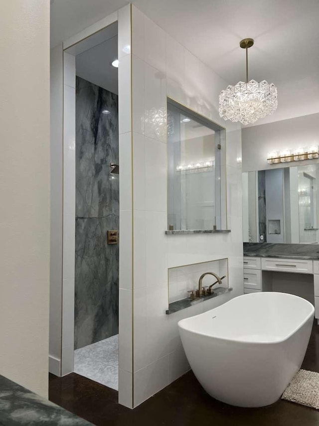 bathroom with separate shower and tub, vanity, tile walls, and a chandelier