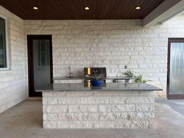 exterior space featuring grilling area, exterior kitchen, and sink