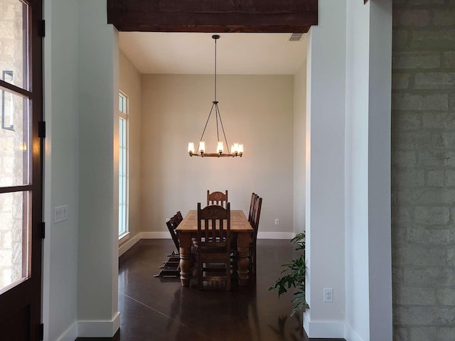 dining area featuring a healthy amount of sunlight and a chandelier