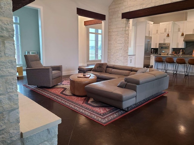 living room featuring lofted ceiling and sink