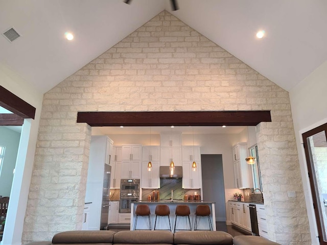 living room with sink and lofted ceiling