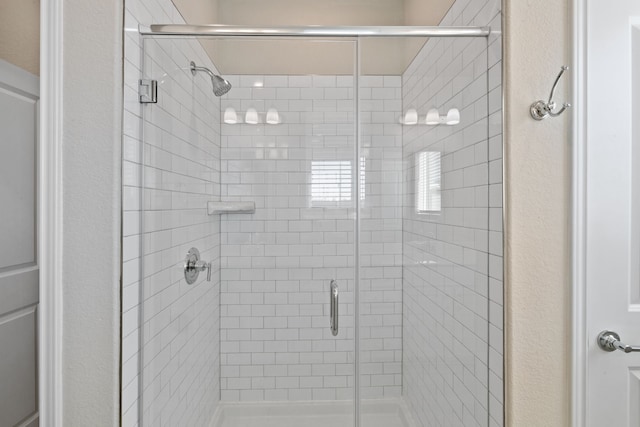 bathroom with a shower with shower door