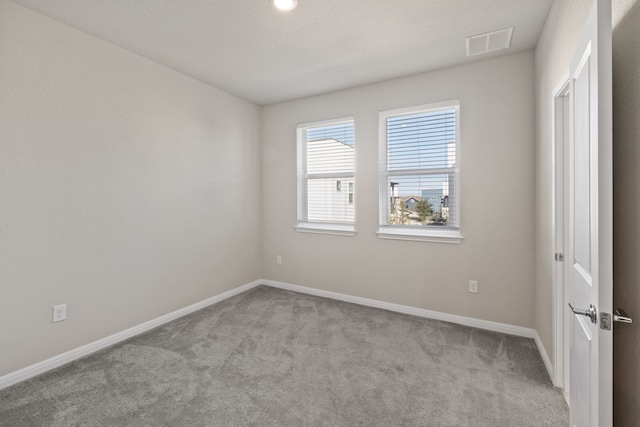 empty room featuring light carpet