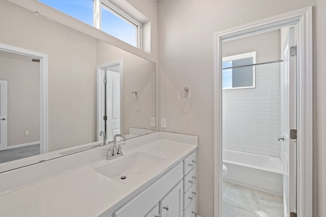 full bathroom with tiled shower / bath combo, vanity, and toilet