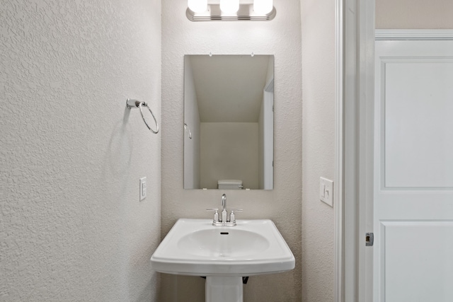 bathroom featuring toilet and sink