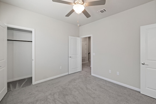 unfurnished bedroom with a closet, light carpet, and ceiling fan