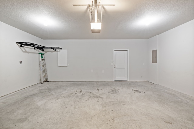 garage featuring electric panel and a garage door opener