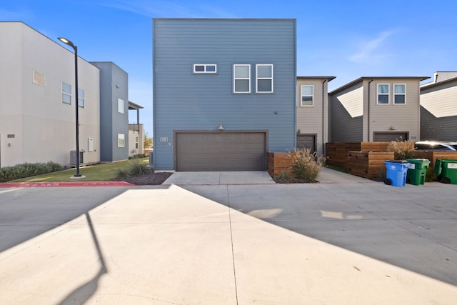 exterior space with central air condition unit and a garage