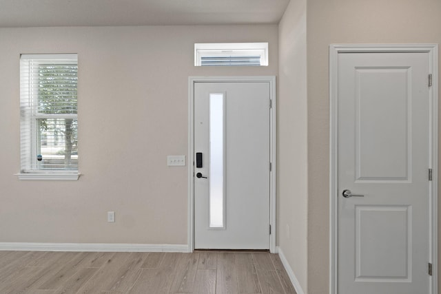 foyer entrance with light hardwood / wood-style flooring