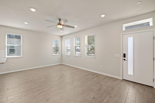 foyer featuring light wood-type flooring and ceiling fan