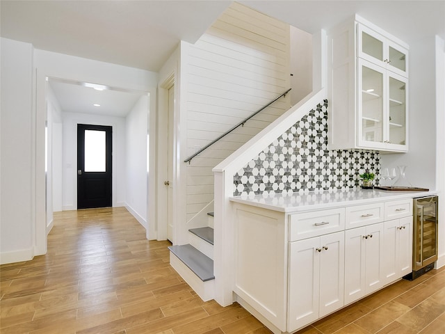 entryway featuring beverage cooler and light wood-type flooring