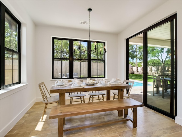 dining room with a wealth of natural light and a notable chandelier