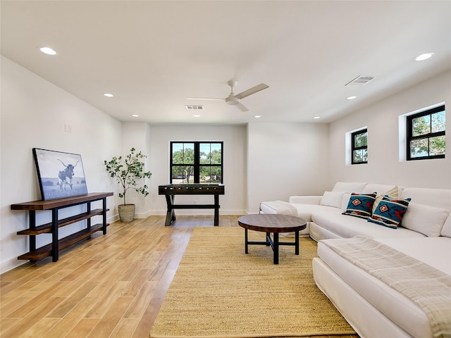 living room with ceiling fan and light hardwood / wood-style floors