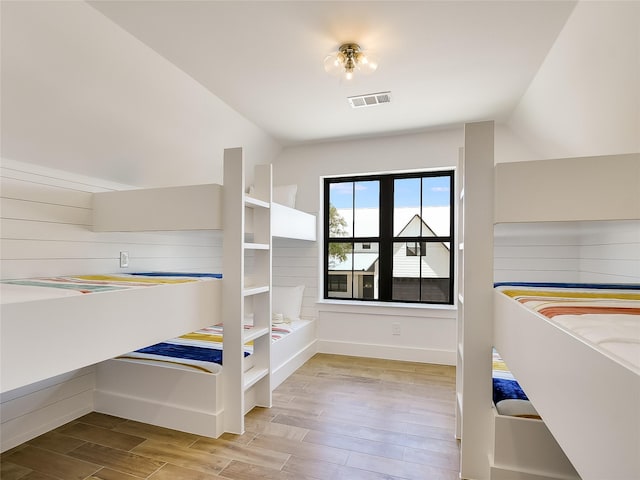 unfurnished bedroom with lofted ceiling