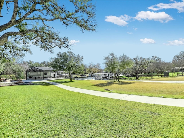 view of property's community with a lawn