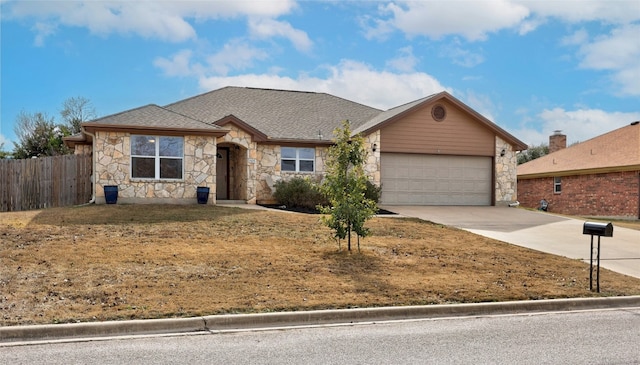 ranch-style home with an attached garage, fence, concrete driveway, stone siding, and roof with shingles