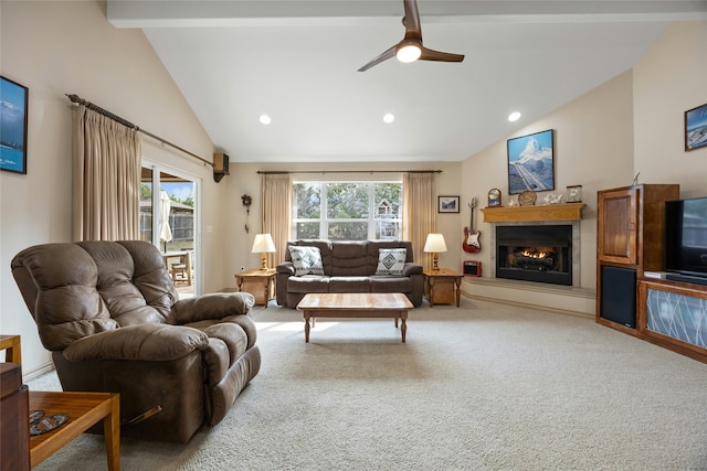 carpeted living room featuring lofted ceiling with beams, a wealth of natural light, and ceiling fan