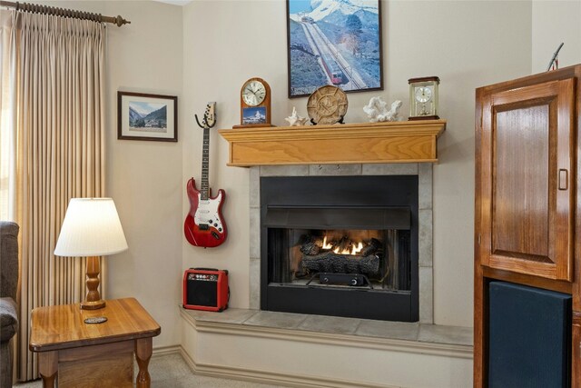 sitting room with a tile fireplace