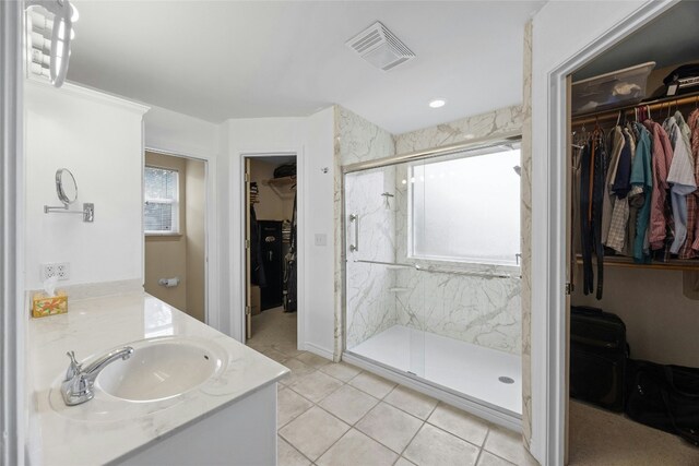 1505 E Johnson St, Burnet, TX 78611 - bathroom featuring plenty of natural light, a spacious closet, vanity, and a marble finish shower