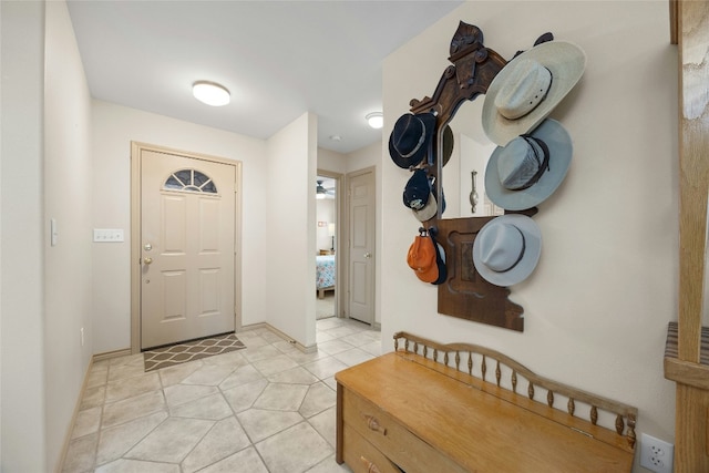 foyer featuring light tile patterned floors and baseboards