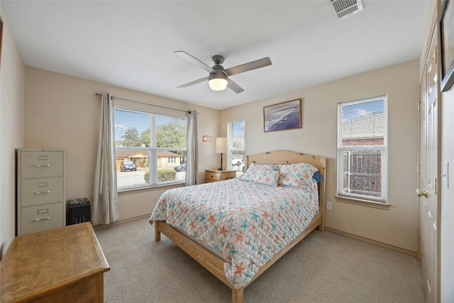 carpeted bedroom with visible vents, ceiling fan, and baseboards