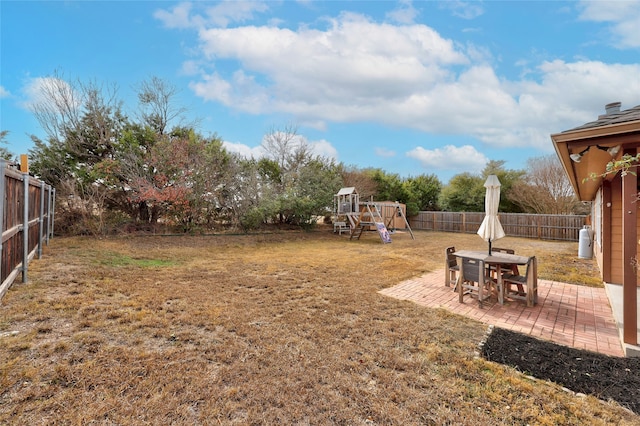 view of yard with a playground and a patio area