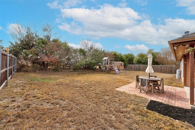 1505 E Johnson St, Burnet, TX 78611 - fenced backyard featuring a playground and a patio