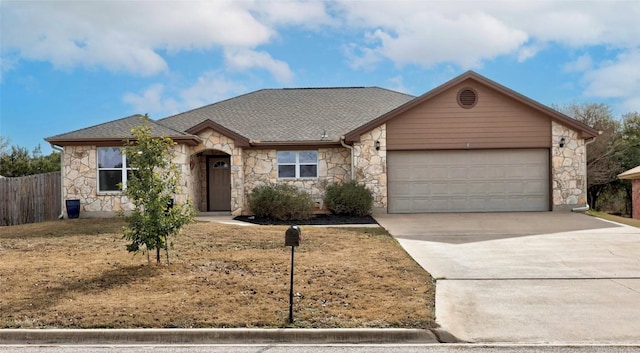 ranch-style house with stone siding, roof with shingles, driveway, and an attached garage