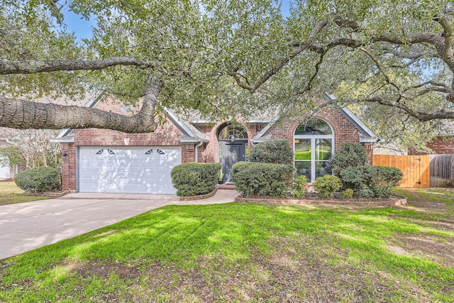 view of front of house featuring a front yard and a garage