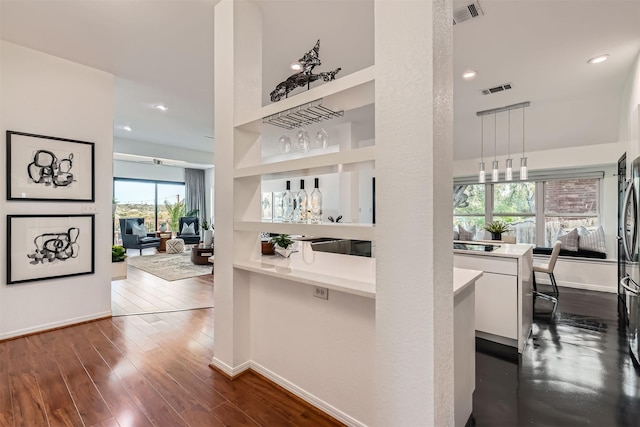 corridor featuring built in features and dark hardwood / wood-style floors