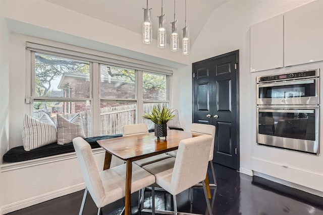 dining room featuring vaulted ceiling