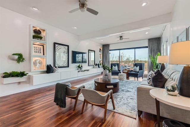 living room with ceiling fan, hardwood / wood-style floors, and beam ceiling