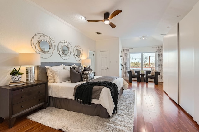 bedroom featuring ornamental molding, ceiling fan, and dark hardwood / wood-style flooring