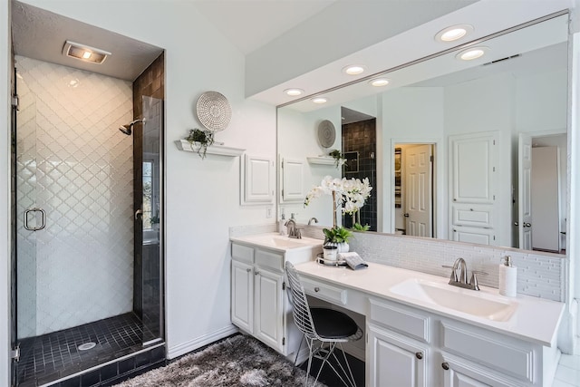 bathroom with walk in shower, tasteful backsplash, and vanity