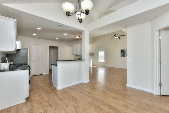 kitchen with white cabinetry, decorative light fixtures, light wood-type flooring, and decorative backsplash