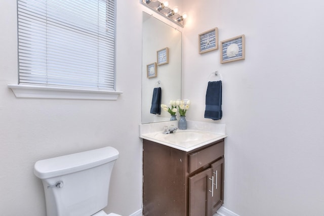 bathroom with toilet and vanity