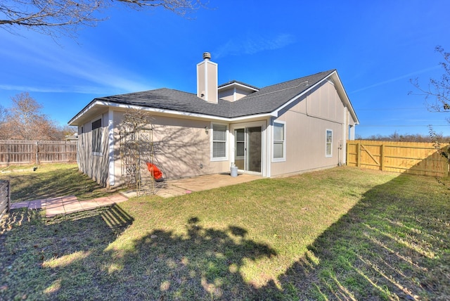 back of property with a patio and a yard